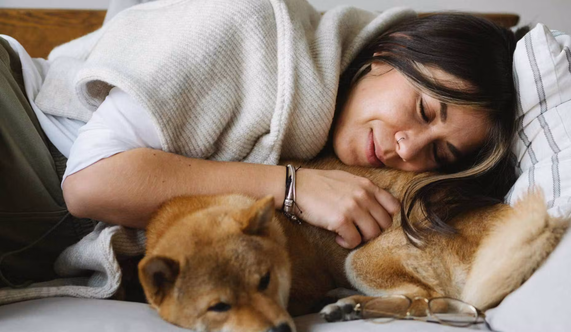 woman cuddling dog